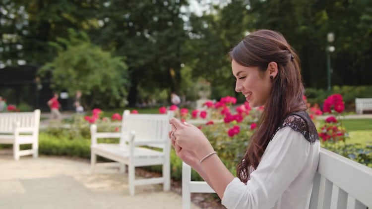 Lady In The Park Gaming On Phone: Stock Video