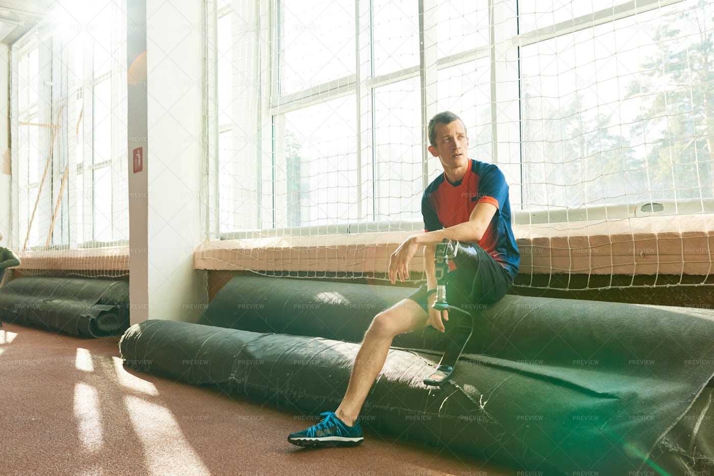 Amputee Sportsman Resting By Window: Stock Photos