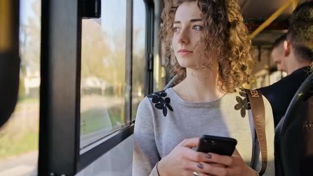 A Young Lady Using a Smartphone on the Bus: Stock Video