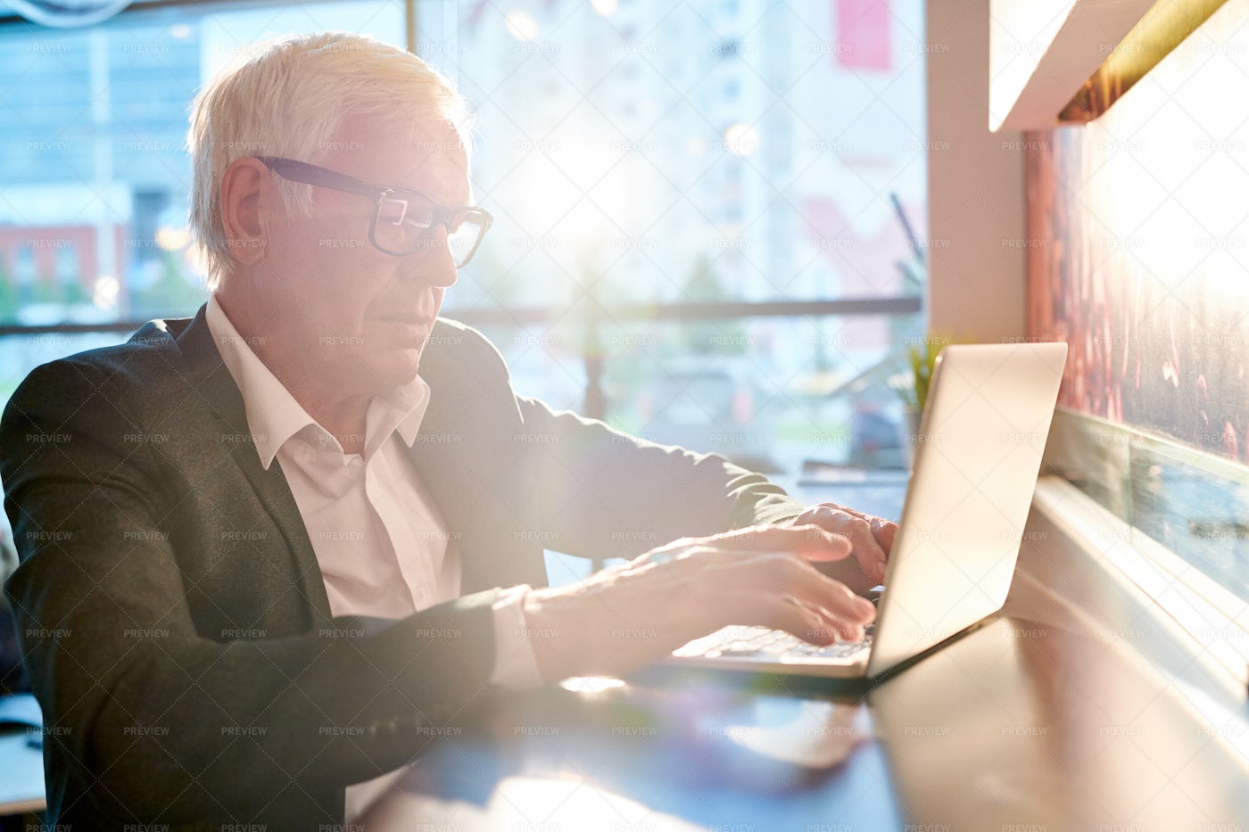 Senior Businessman Using Laptop In...: Stock Photos