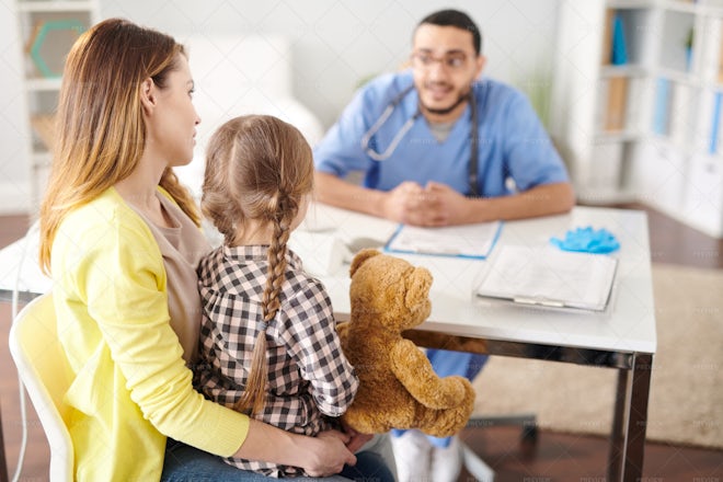 Mother With Little Girl In Doctors... - Stock Photos | Motion Array