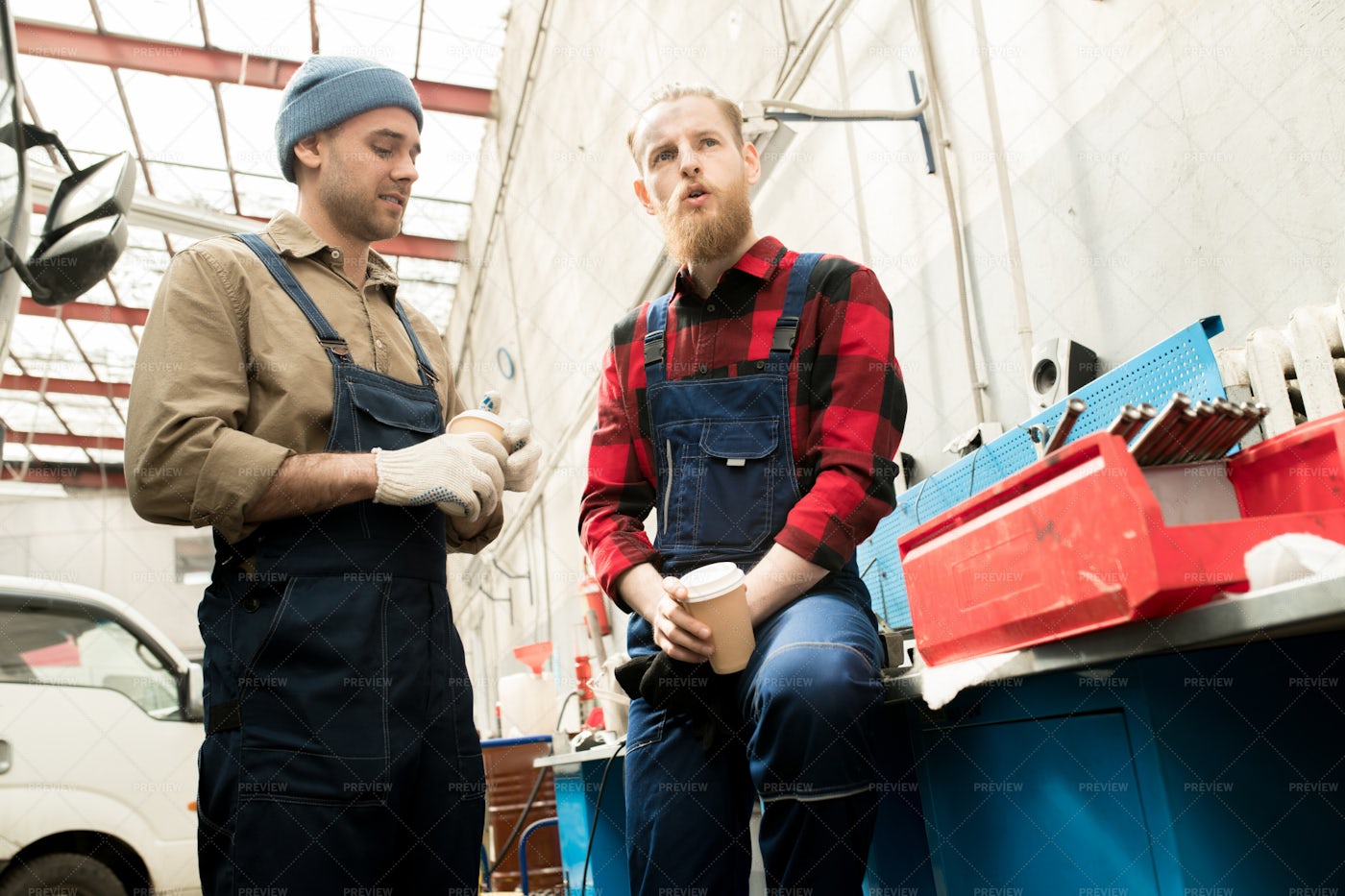 Auto Mechanics Chatting On Break: Stock Photos