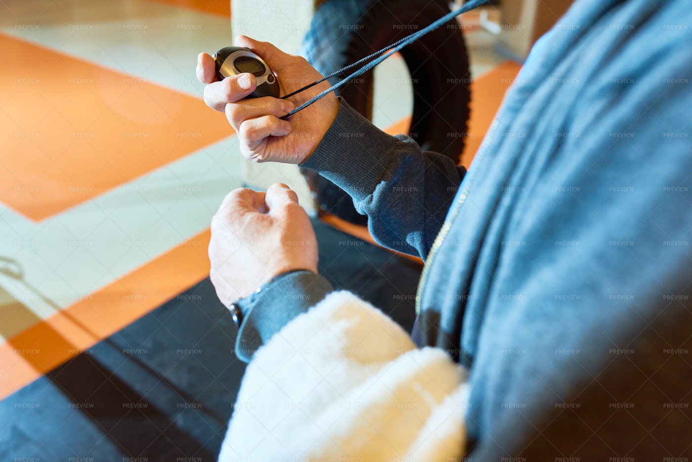 Crop Coach Setting Time In Gym: Stock Photos