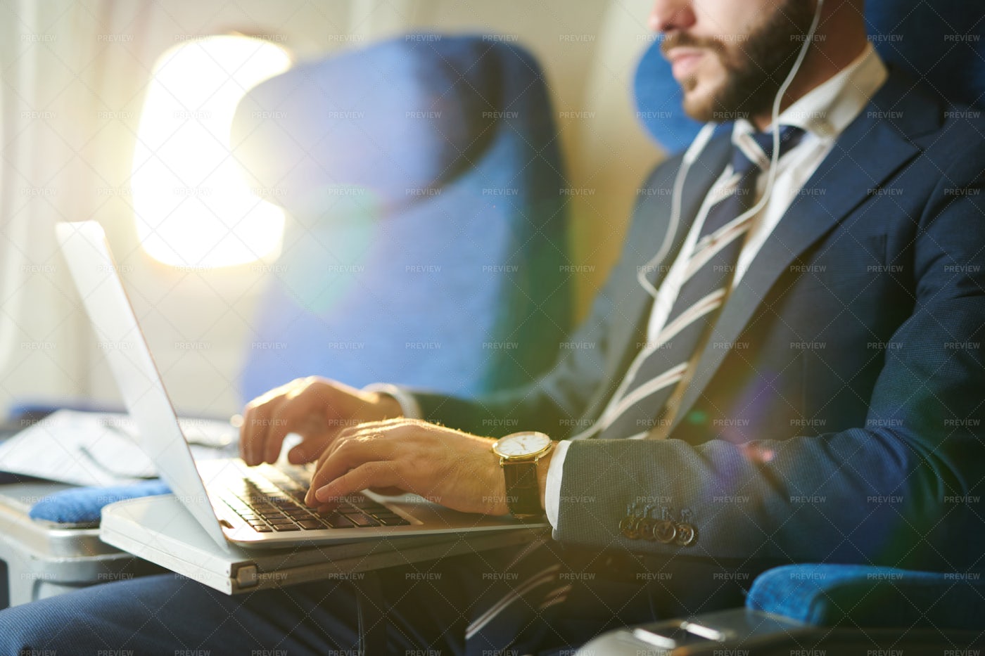 Businessman Using Laptop In Plane...: Stock Photos