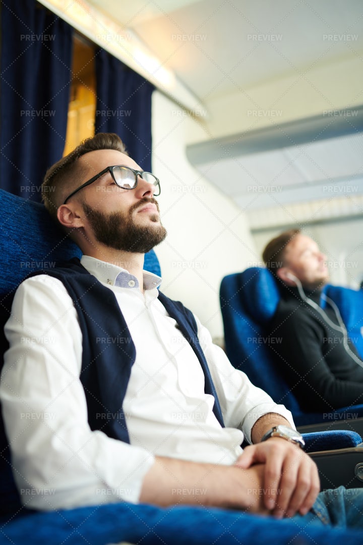 Young Man Sleeping In Plane: Stock Photos