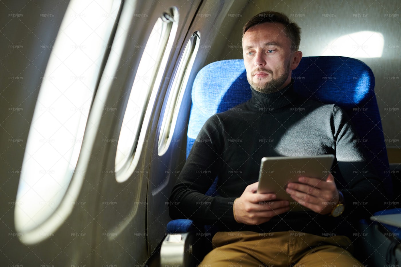 Pensive Man Holding Tablet In...: Stock Photos