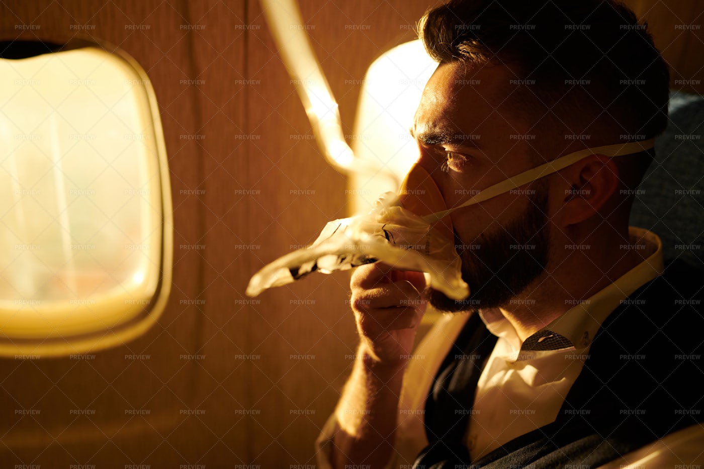 Man Breathing Oxygen In Plane: Stock Photos