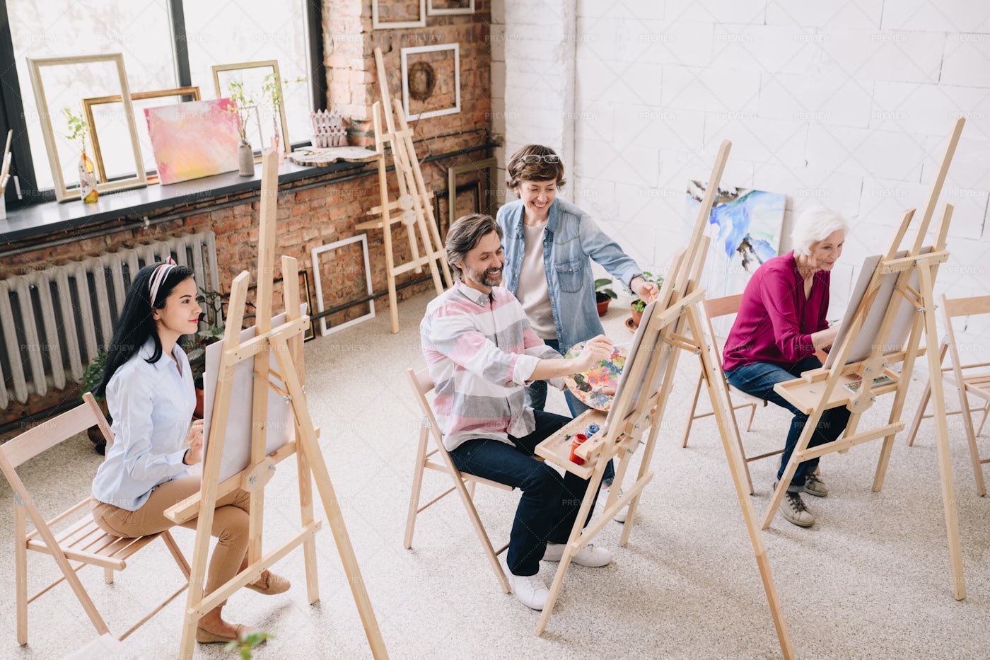 Students Painting At Easels In Art...: Stock Photos
