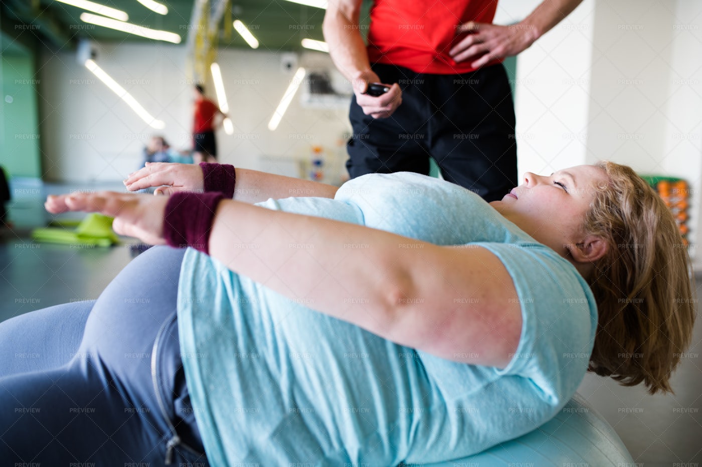 Obese Woman Exercising On Fitness...: Stock Photos