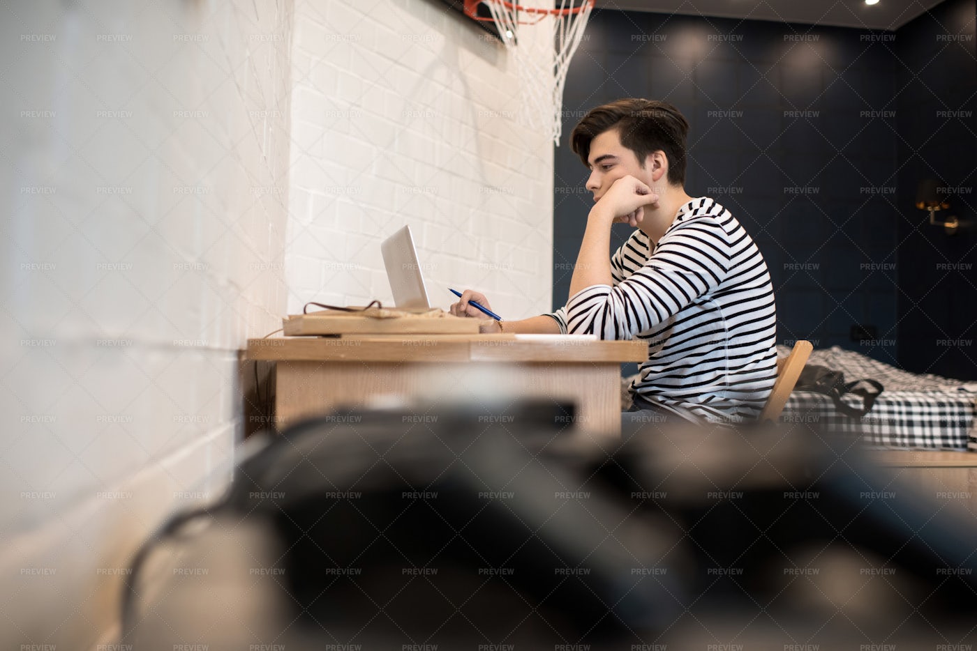 Concentrated Young Man Sitting At...: Stock Photos
