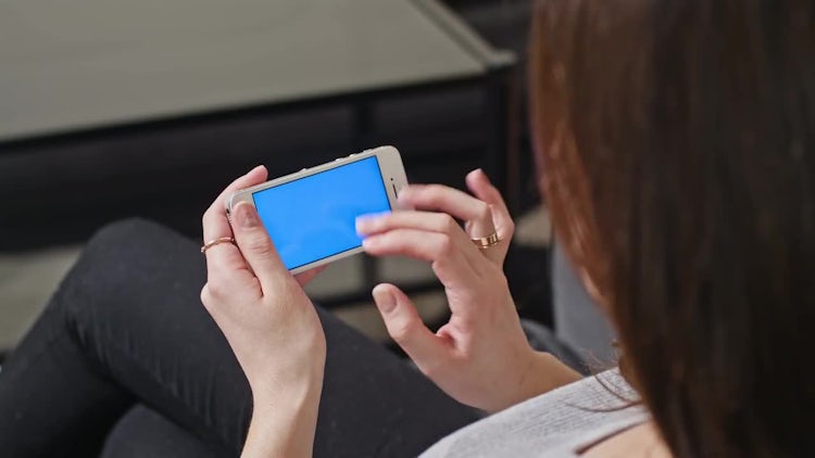 Woman is Holding Phone with Blue Screen: Stock Video
