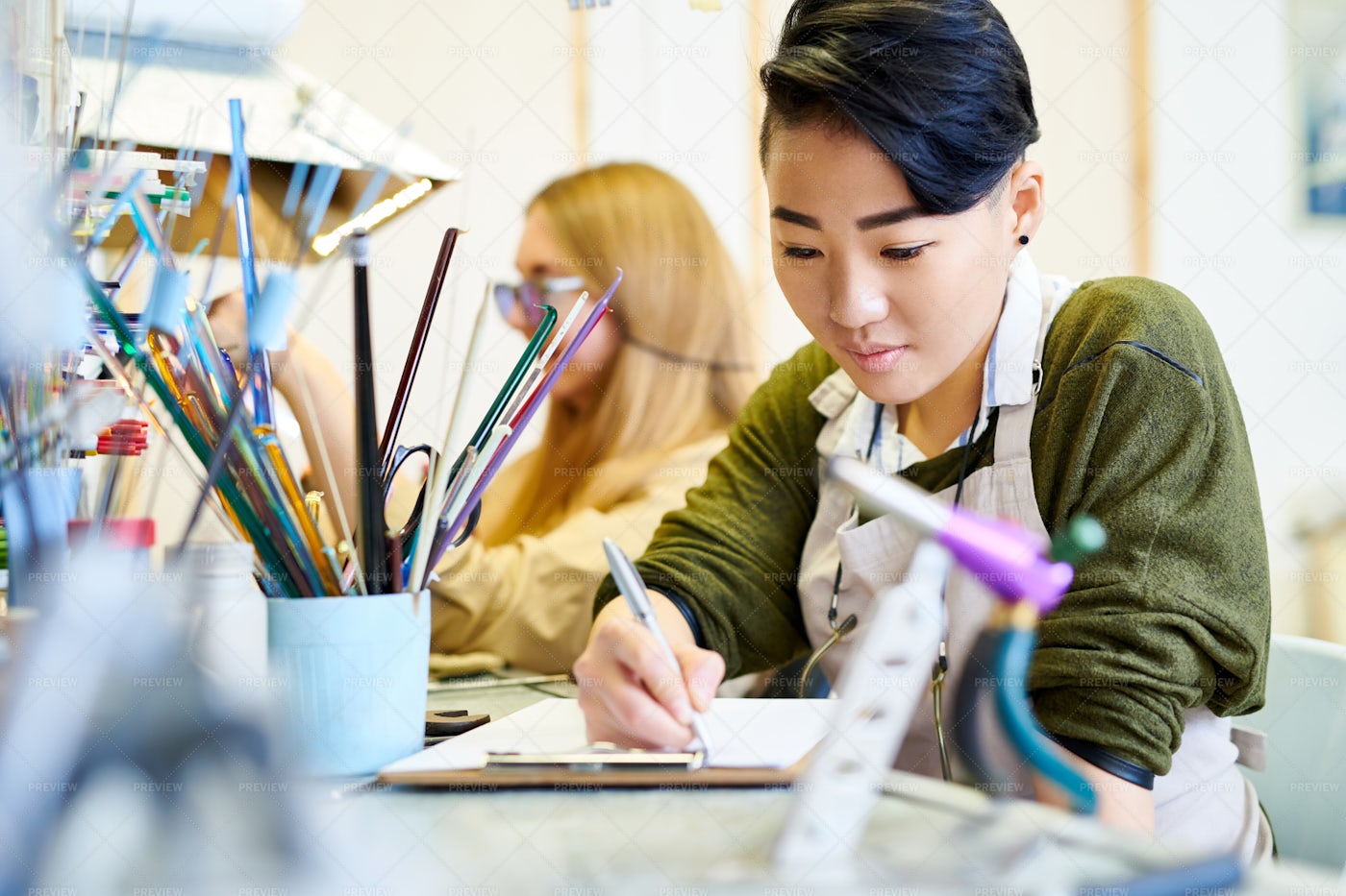 Creative Woman Drawing In Workshop: Stock Photos