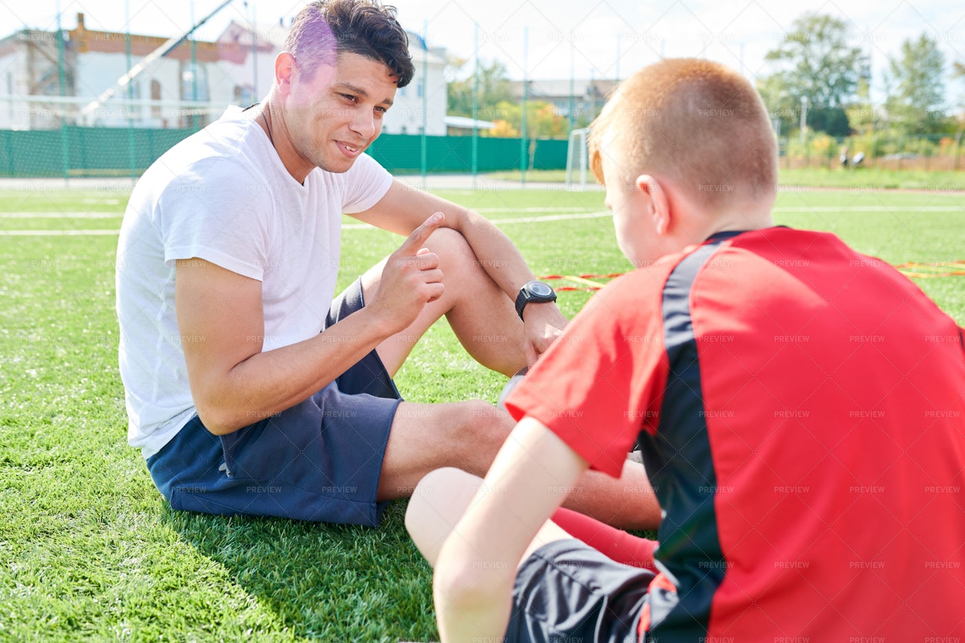 Sports Coach Talking To Boy: Stock Photos