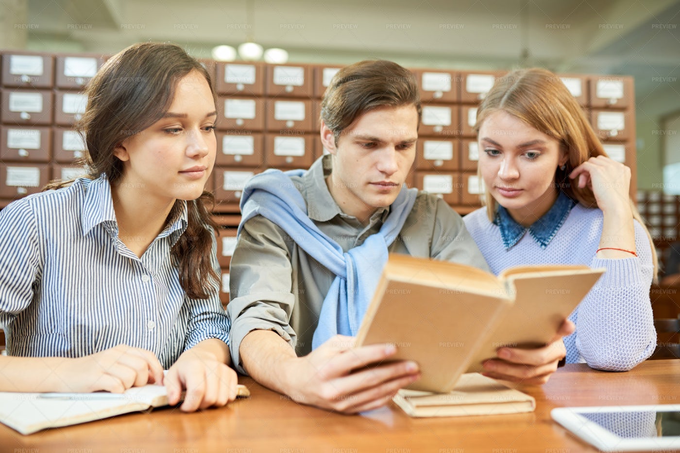College Students Reading Textbook...: Stock Photos