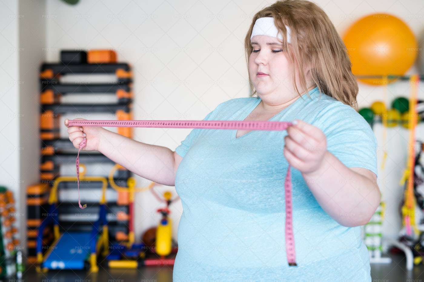 Obese Woman Holding Tape Measure: Stock Photos