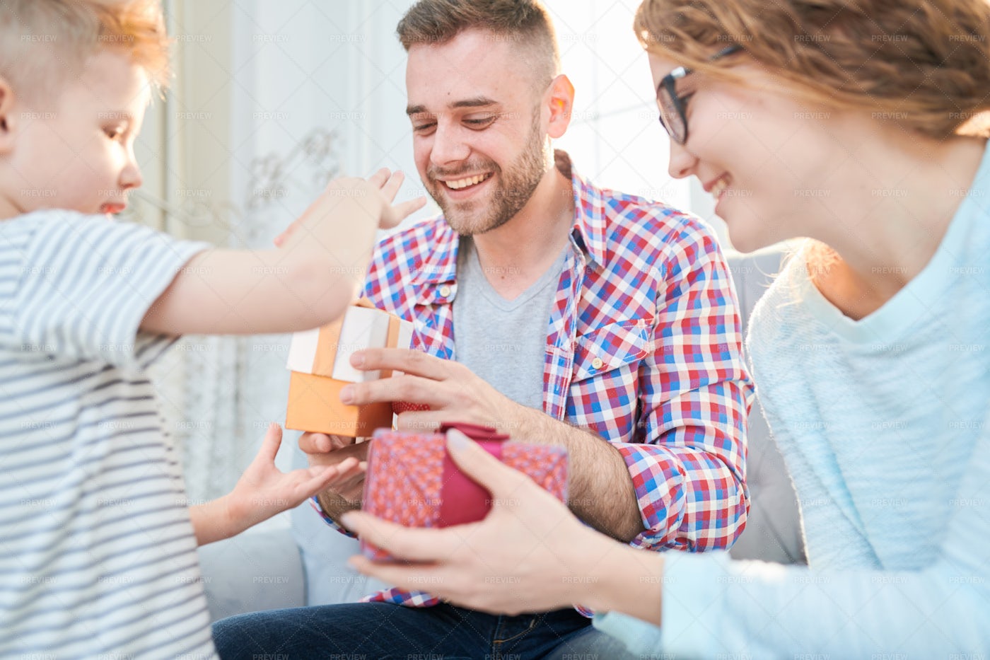 Boy Giving Presents To Parents Stock Photos Motion Array