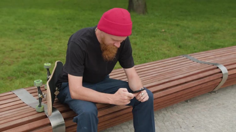 Redhead Hipster With Phone And Skateboard: Stock Video