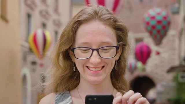 Woman Using A Mobile Phone Outdoors: Stock Video