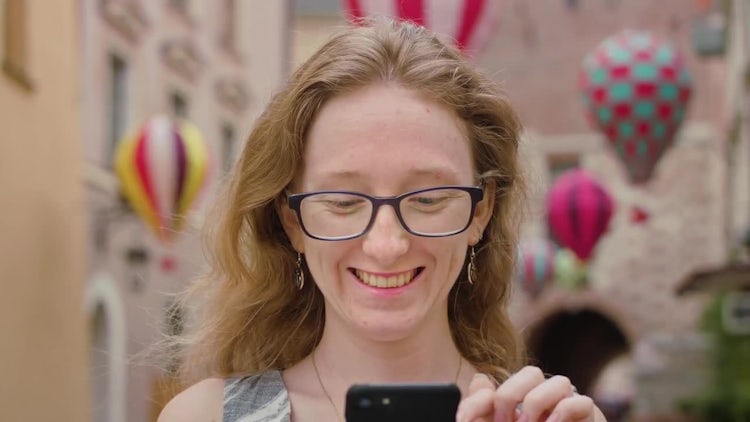 Woman Using A Mobile Phone Outdoors: Stock Video