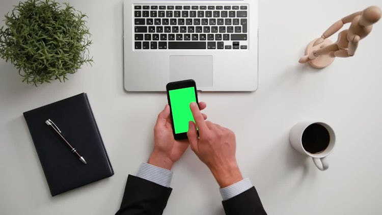 Hands Holding A Phone With Green Screen: Stock Video