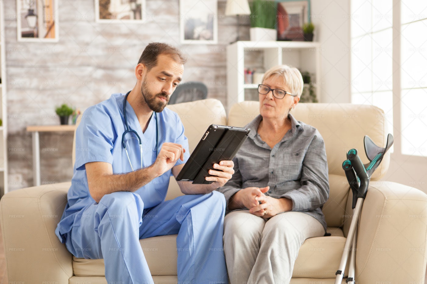 Nurse Reads From A Tablet: Stock Photos