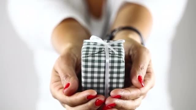 Young Girl in Blur Showing Gift Box on Her Hand: Stock Video