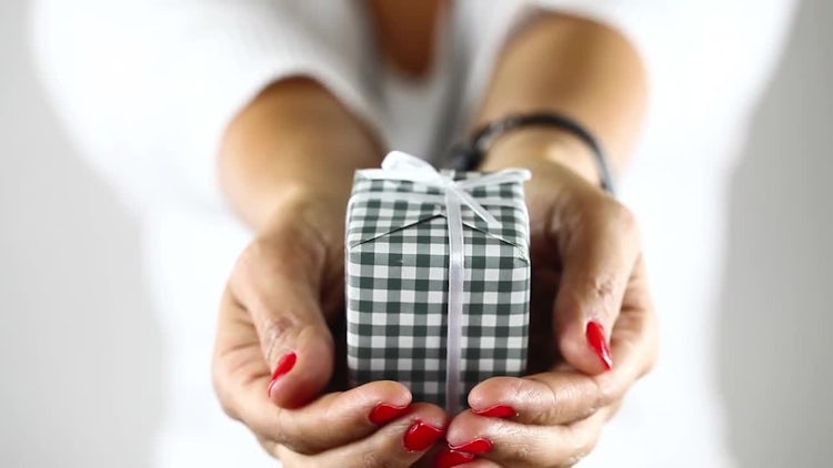 Young Girl in Blur Showing Gift Box on Her Hand: Stock Video