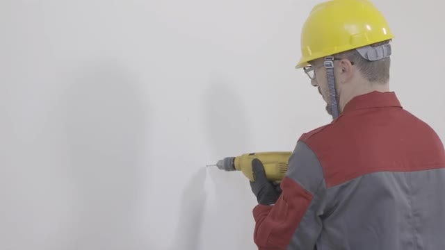 Worker Drilling A Hole In The Wall: Stock Video