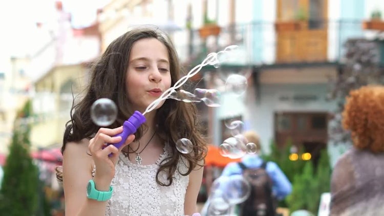 Little Girl Makes Soap Bubbles: Stock Video