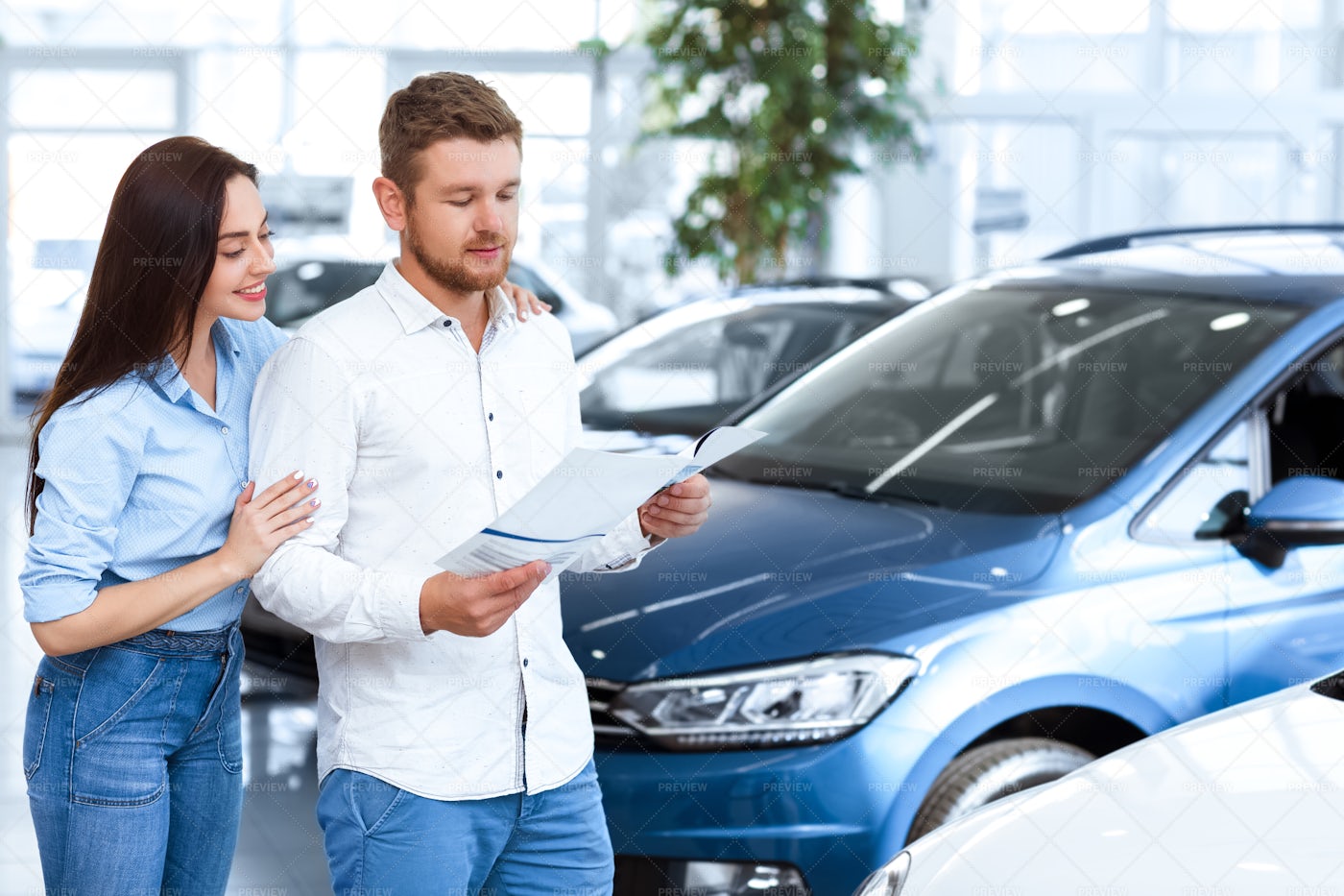 Looking At Car Catalogue: Stock Photos