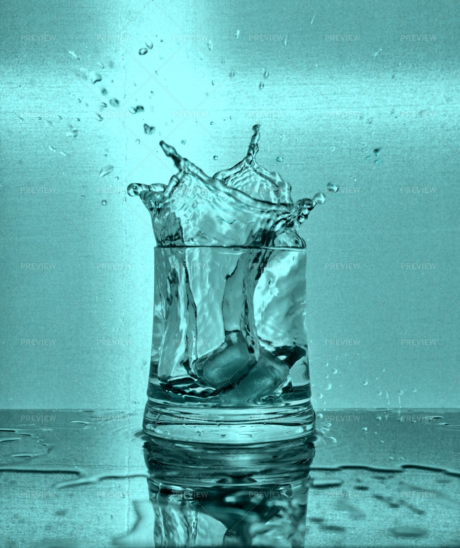 Ice Cubes Splash Into Water: Stock Photos