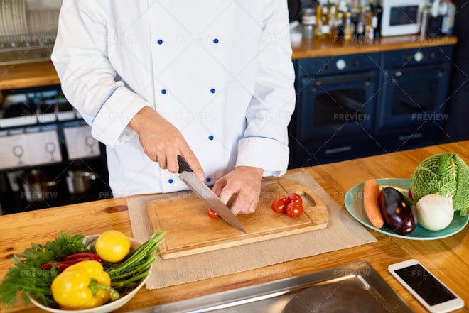 Chef is chopping vegetables Stock Photo by grafvision