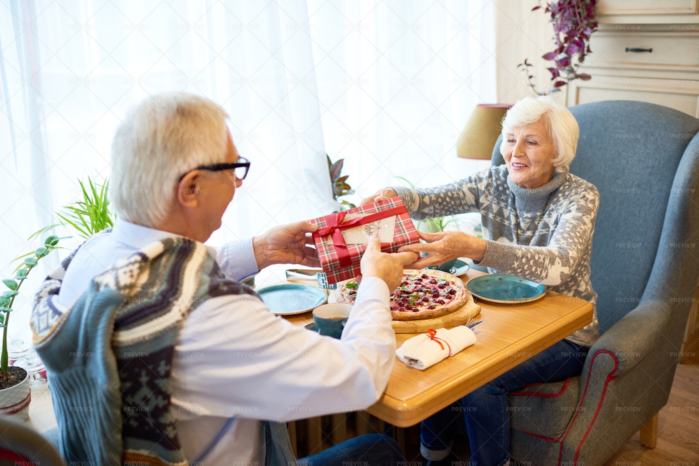 Senior Couple Exchanging Gifts: Stock Photos
