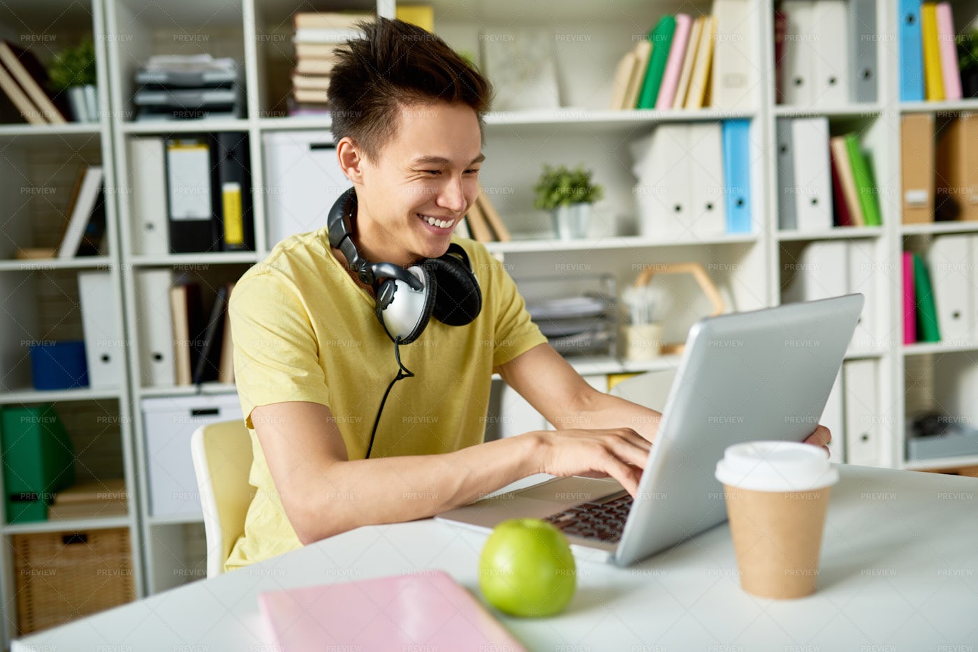 Happy Asian Student Using Laptop: Stock Photos