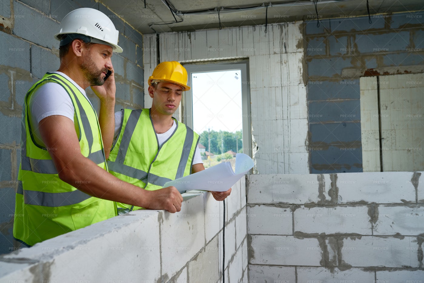 Two Workers With Floor Plans: Stock Photos