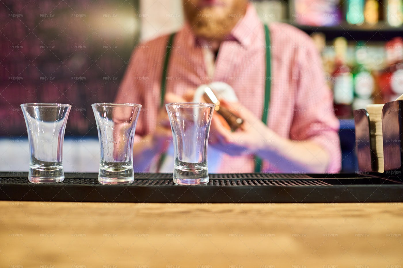 Bartender Cleaning Up At Bar...: Stock Photos