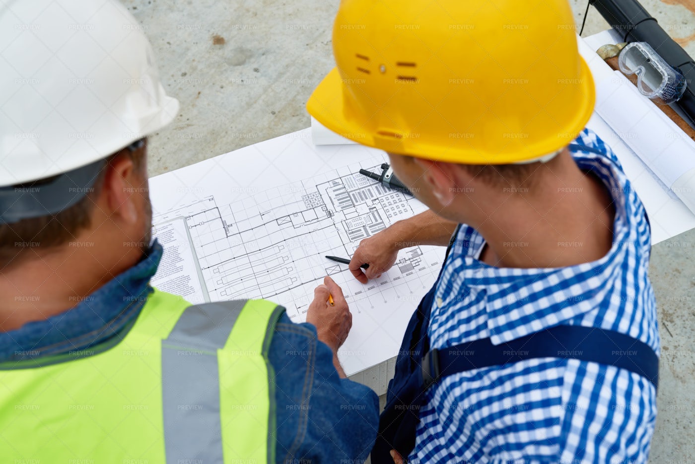 Builders Checking Floor Plans On...: Stock Photos