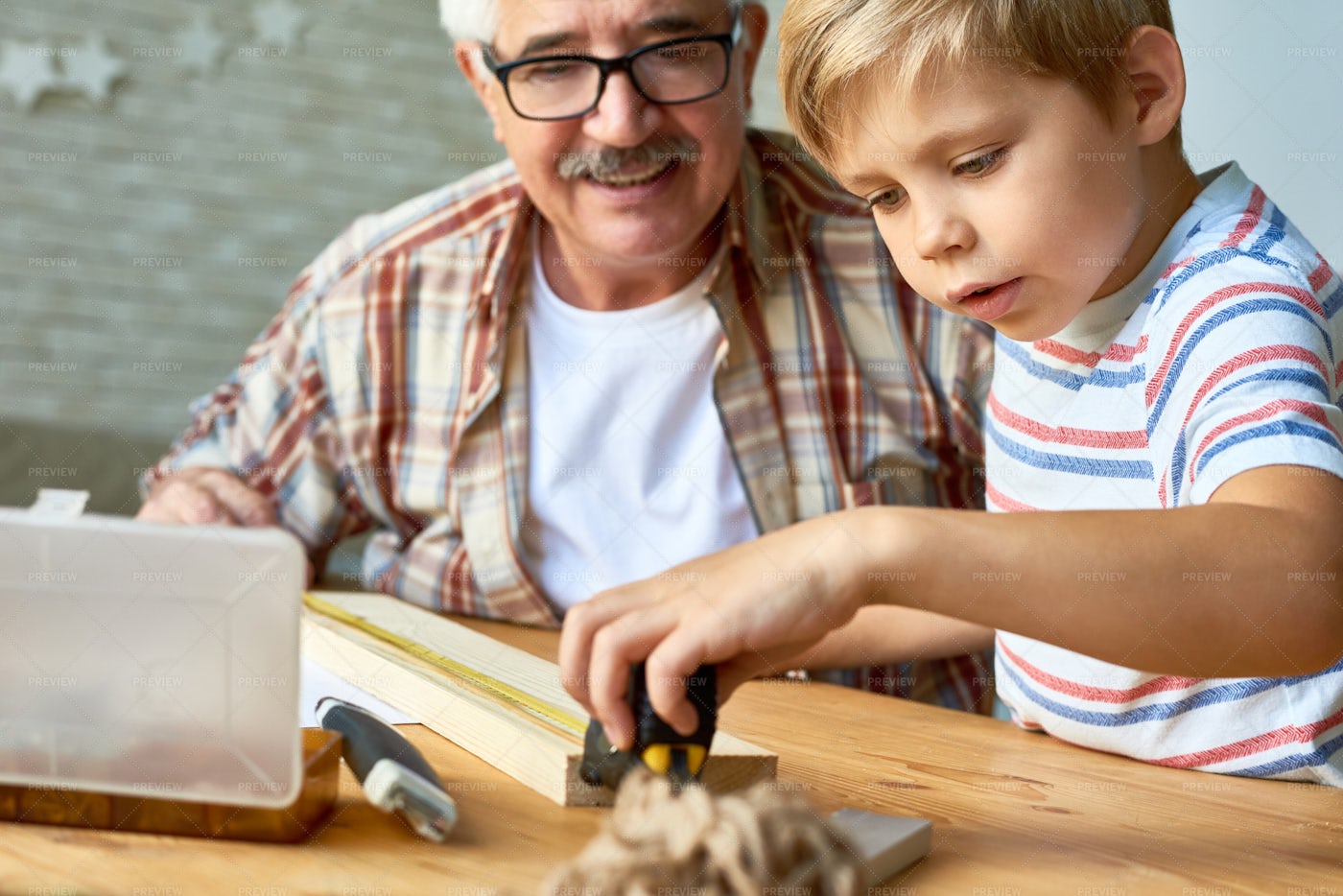 Grandfather And Little Boy Working...: Stock Photos