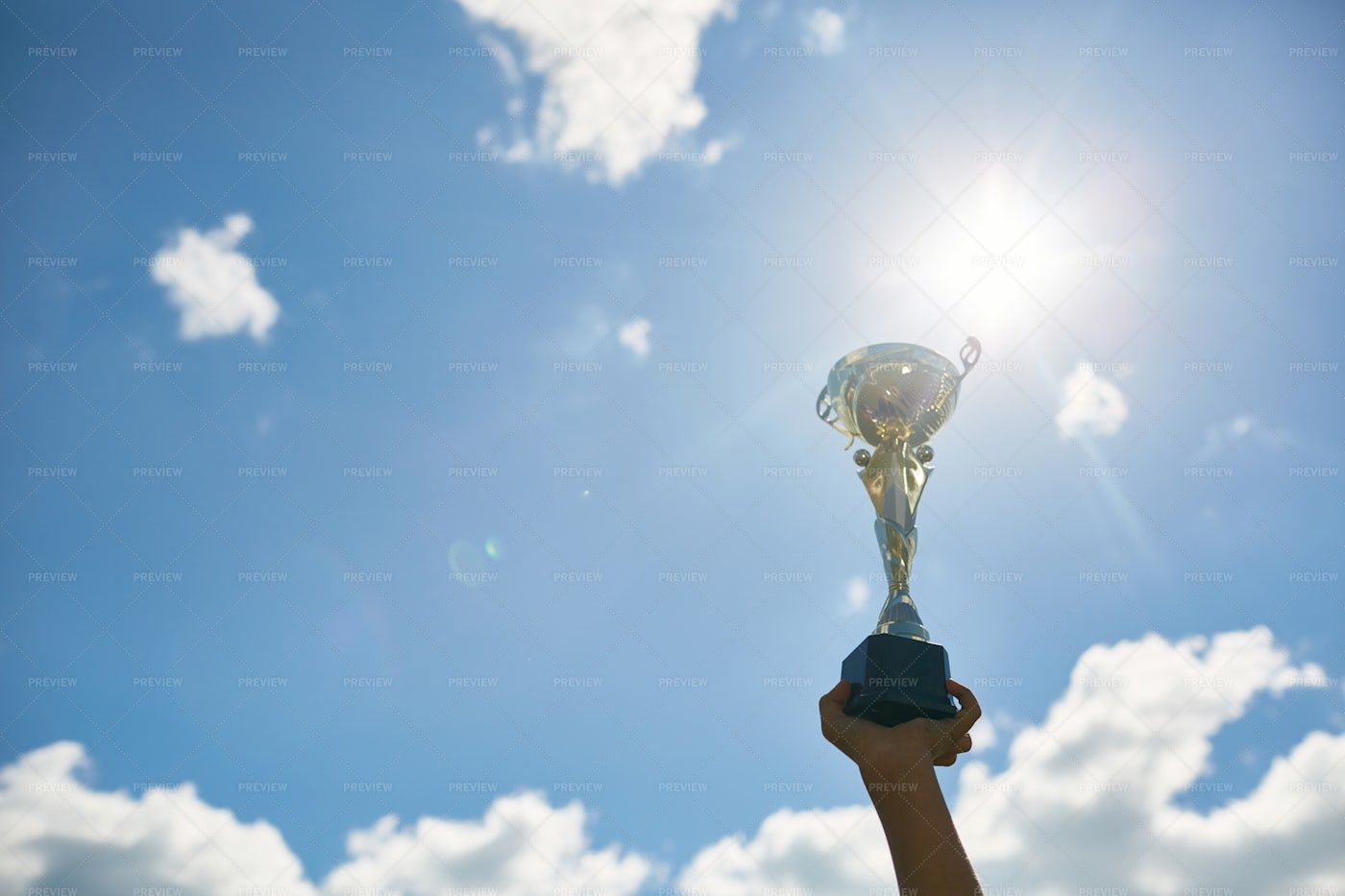 Golden Trophy Cup Against Sky: Stock Photos