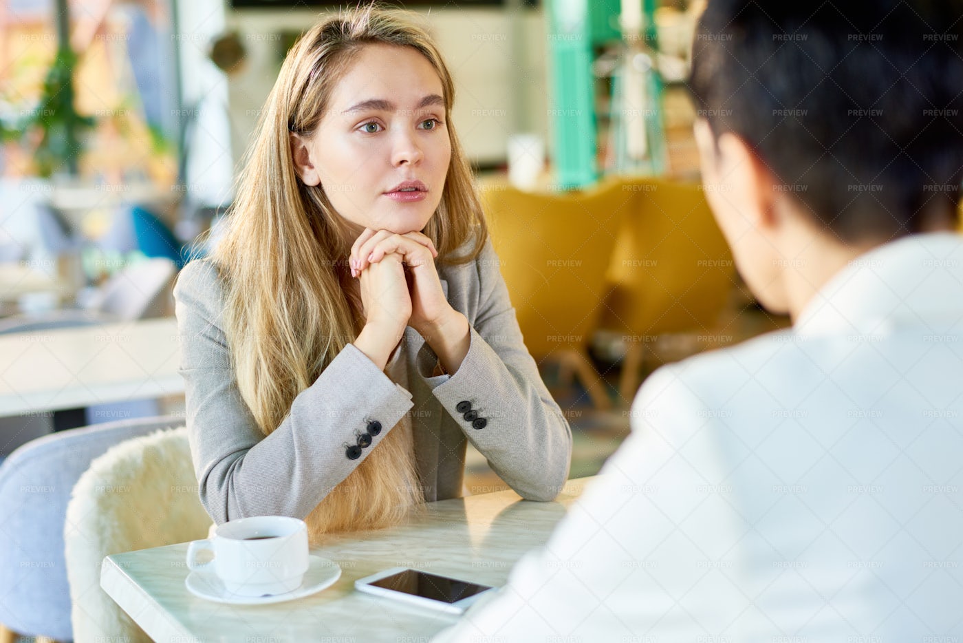 Young Woman Talking With Person At...: Stock Photos
