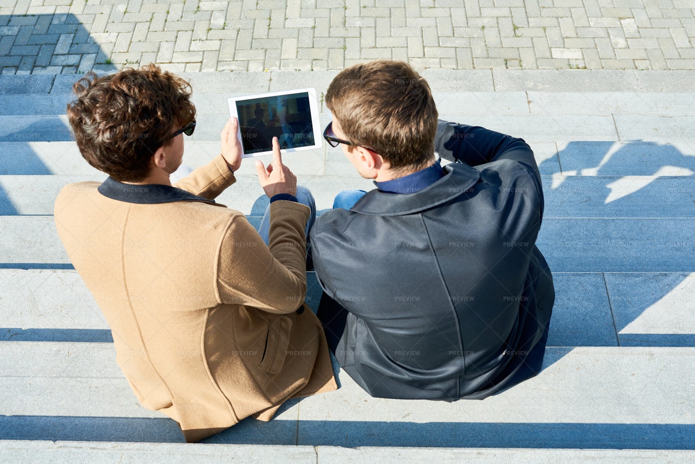 Two Men Using Tablet Outdoors: Stock Photos