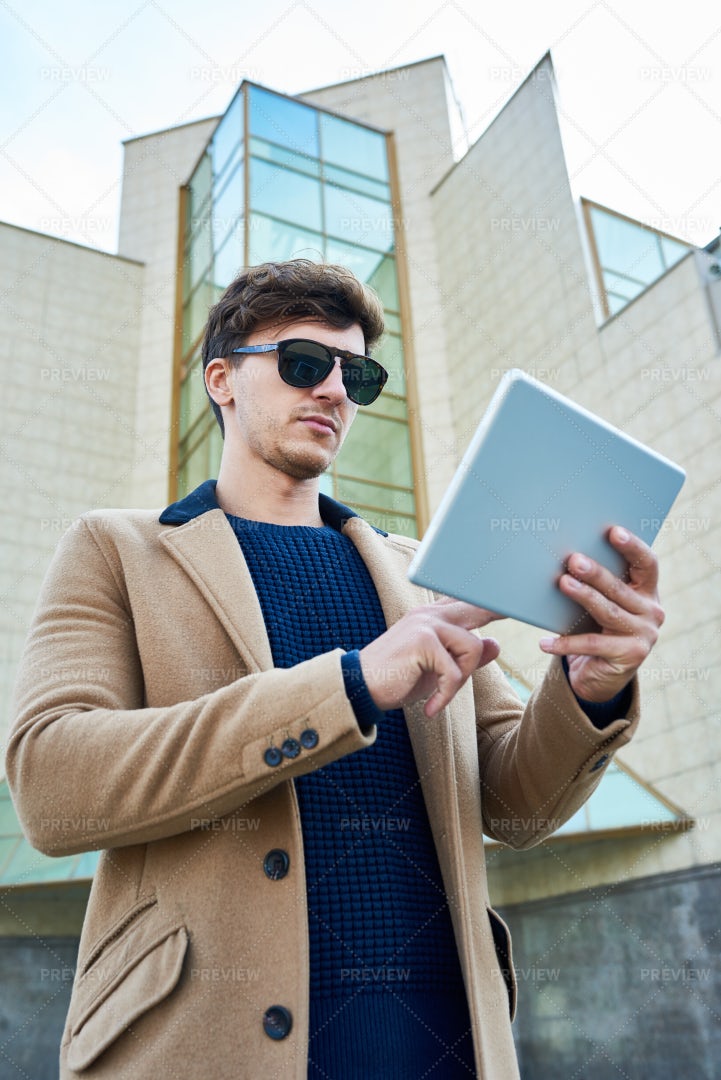 Handsome Businessman Using Tablet...: Stock Photos