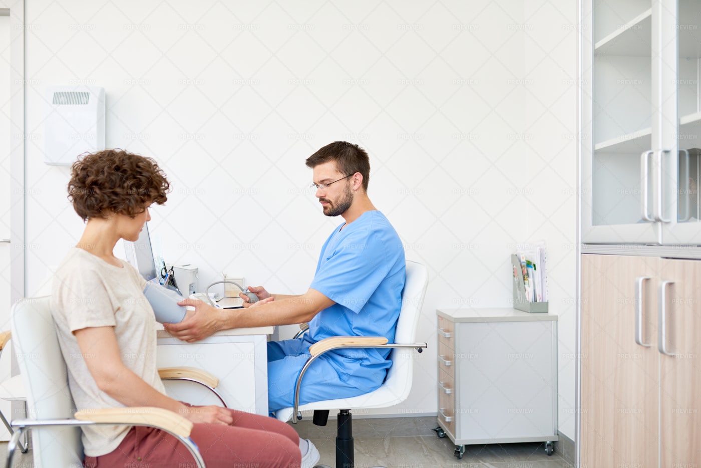 Doctor Measuring Blood Pressure On...: Stock Photos