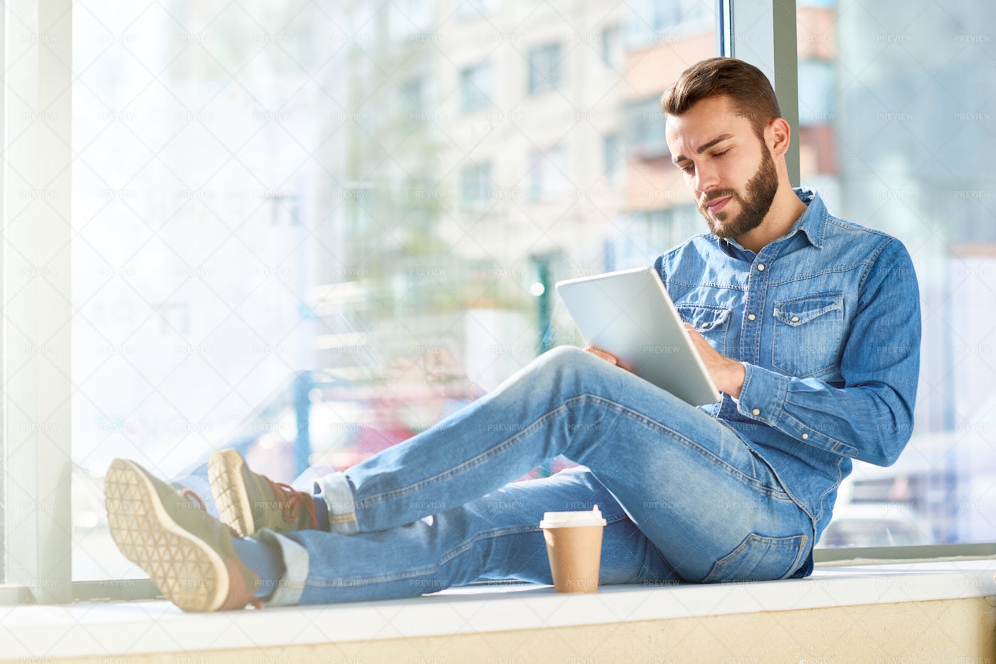 Modern Man Working On Sunlit Window: Stock Photos
