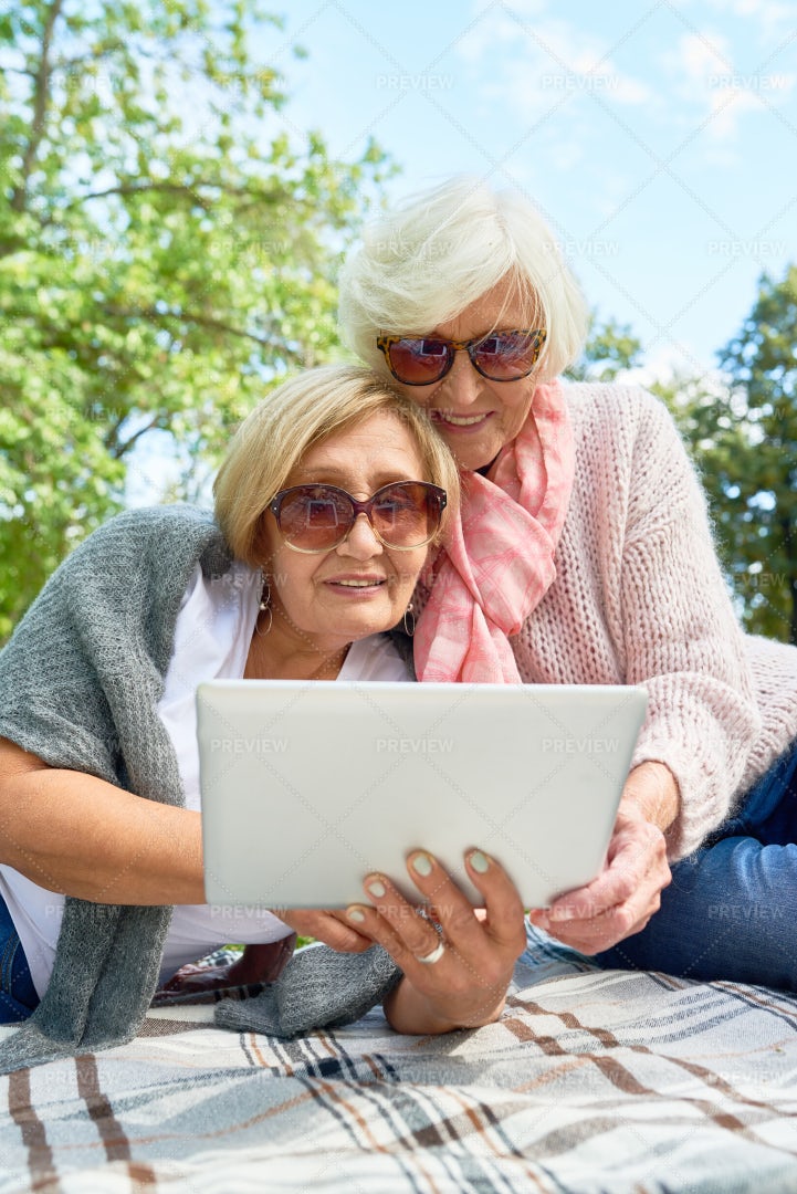 Senior Women Using Laptop In Park: Stock Photos