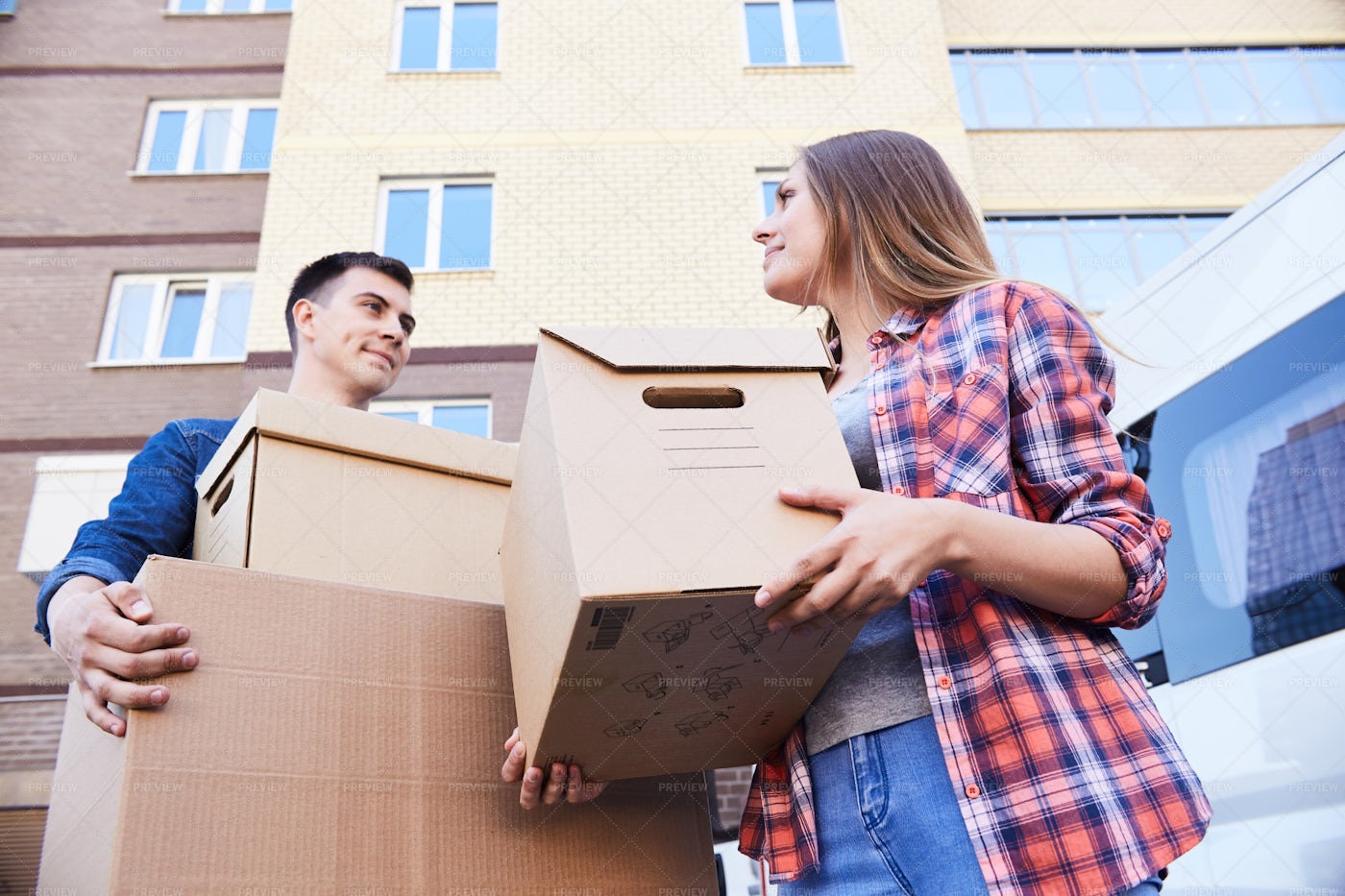 Couple Holding Boxes While Moving: Stock Photos