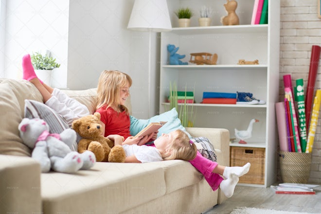 Reading Aloud To Little Sister - Stock Photos | Motion Array