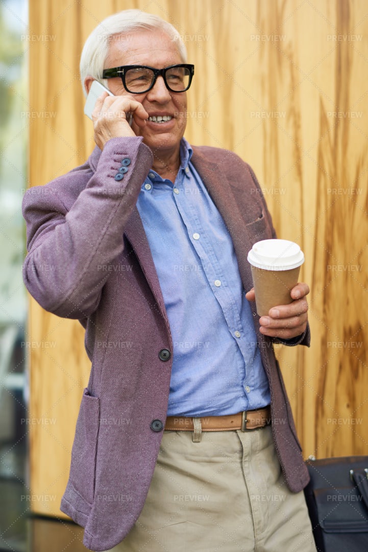Contemporary Senior Man Speaking By...: Stock Photos