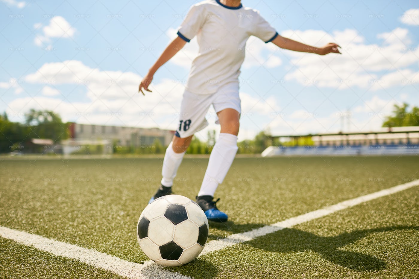 Boy In Uniform Kicking Ball On...: Stock Photos