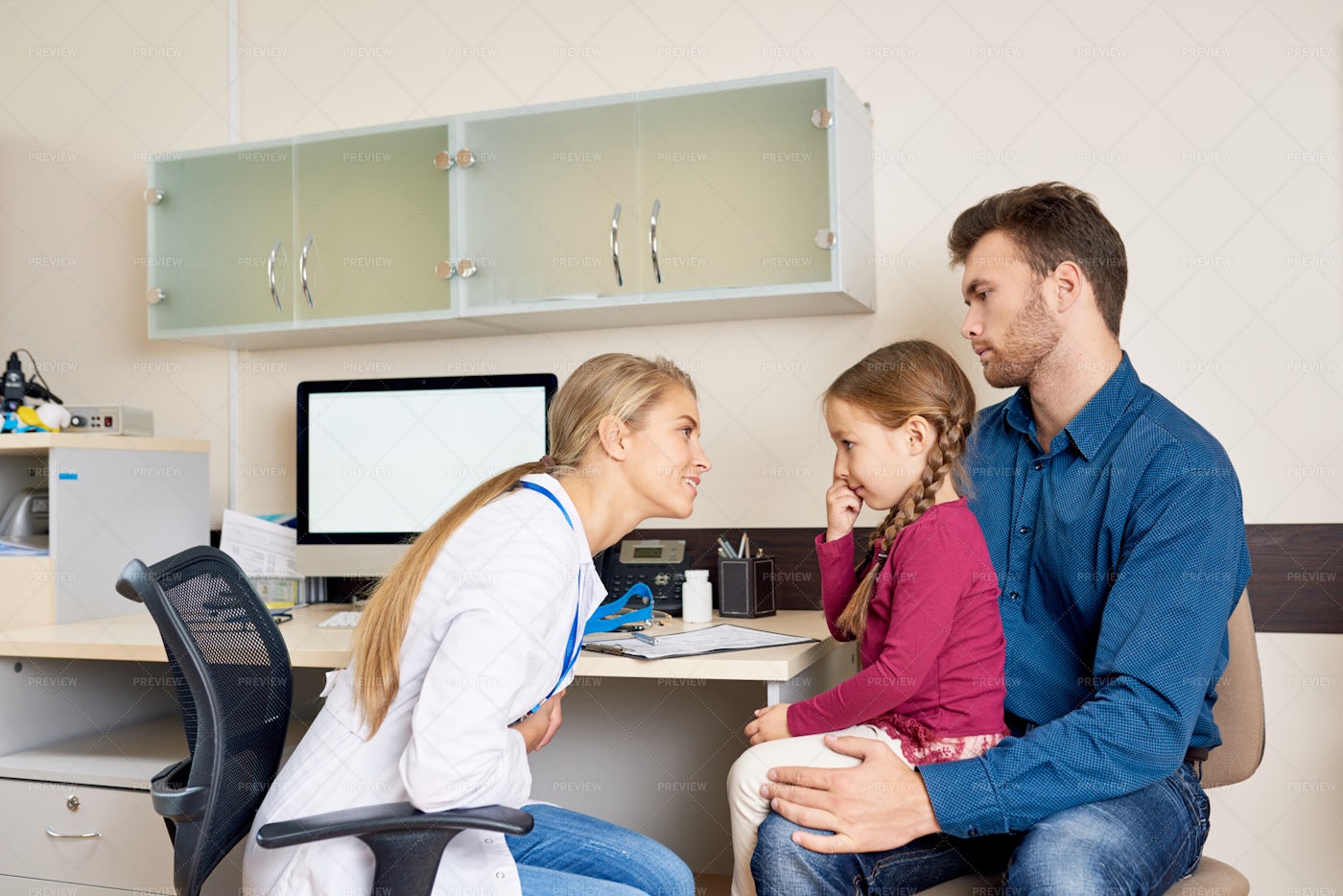 Father And Daughter In Doctors...: Stock Photos